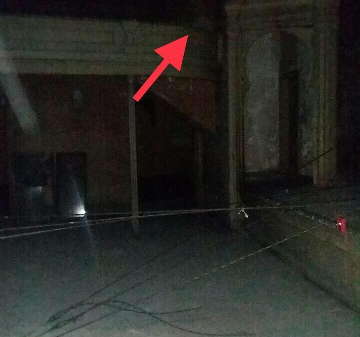 Arrow pointing towards an authentic ghost on the balcony of old opera house