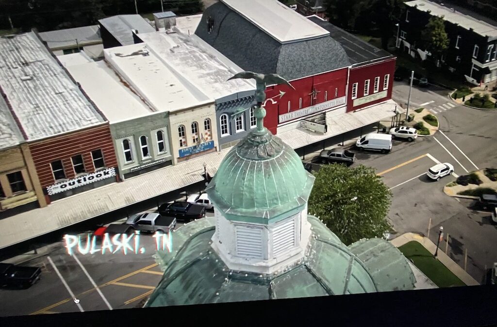 sky view of the top of the courthouse and stores on the town square